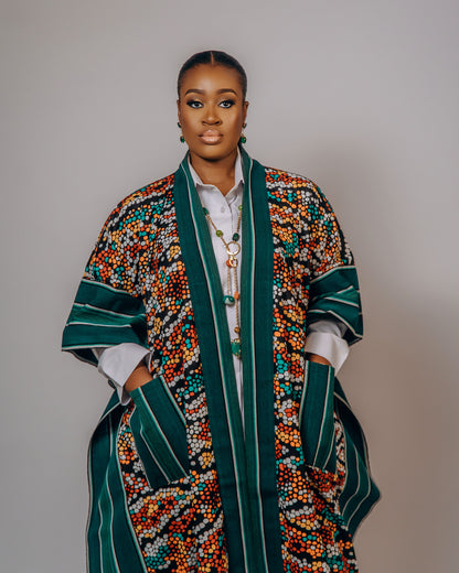 Woman wearing a colorful patterned coat against a plain background