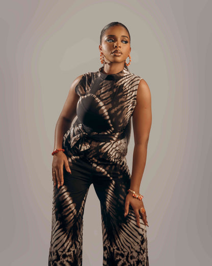 Woman wearing a patterned outfit against a plain background